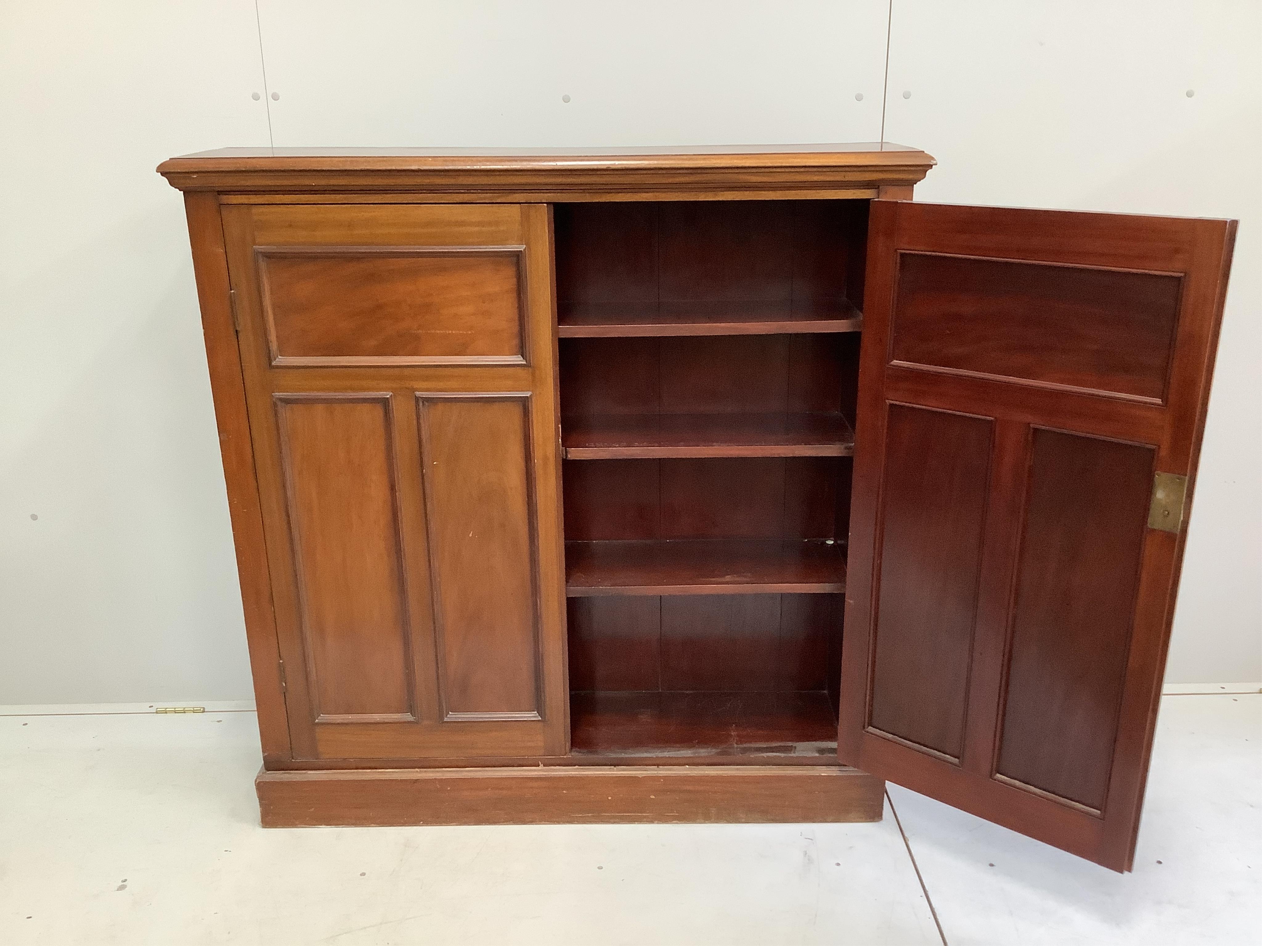 An Edwardian mahogany two door side cabinet, (loose plinth), width 124cm, depth 29cm, height 126cm